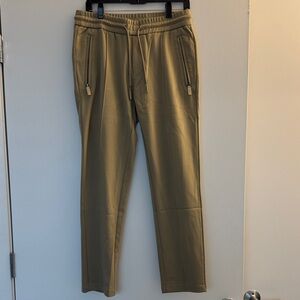 Men's Tan Pants with lots of details.